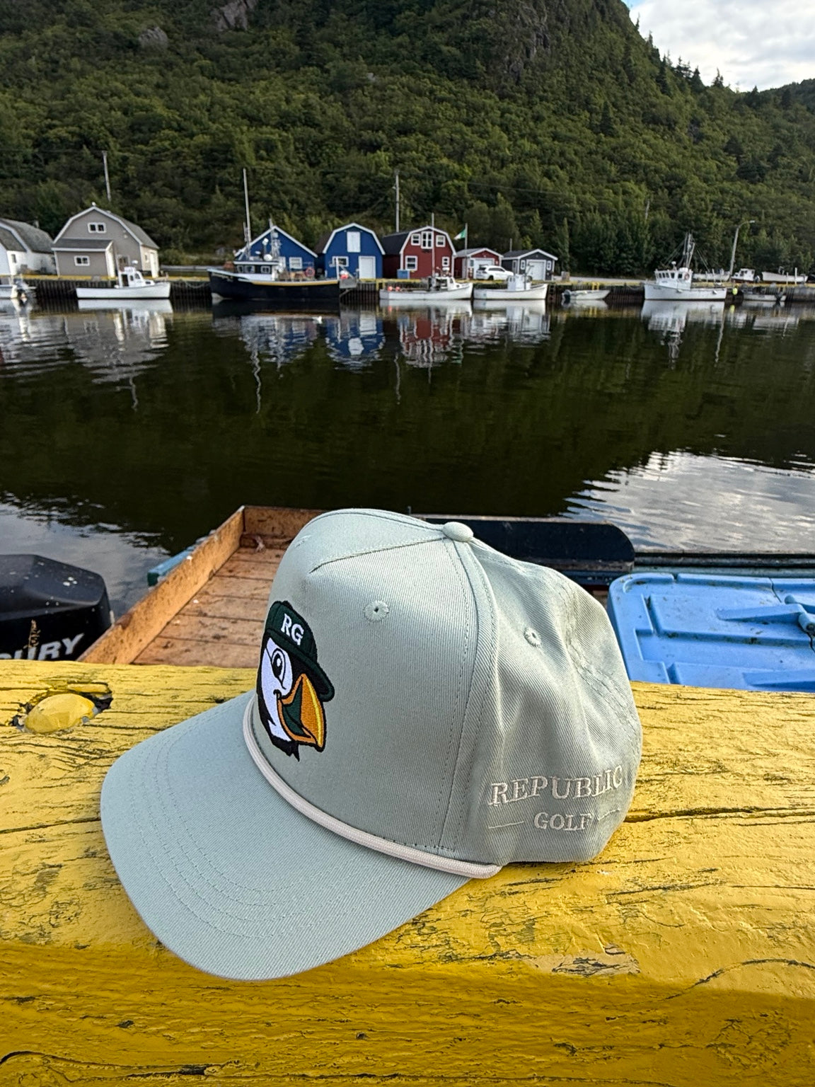 Republic Golf Puffin Rope Hat photographed at a Newfoundland harbour