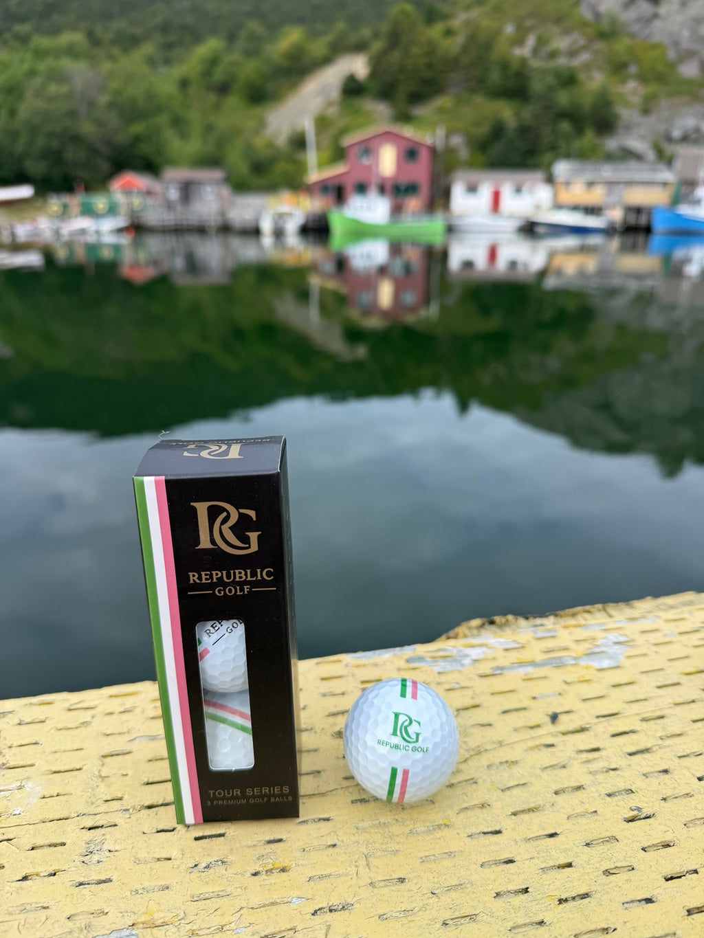Republic Golf Tour Series golf balls photographed at a Newfoundland harbour